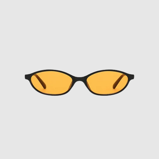 Sunglasses with yellow lenses and black frames on a light gray background