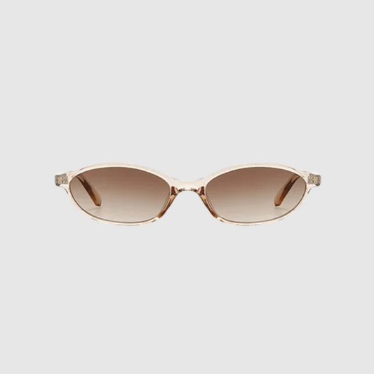 Sunglasses with clear frame and brown gradient lenses on a light gray background