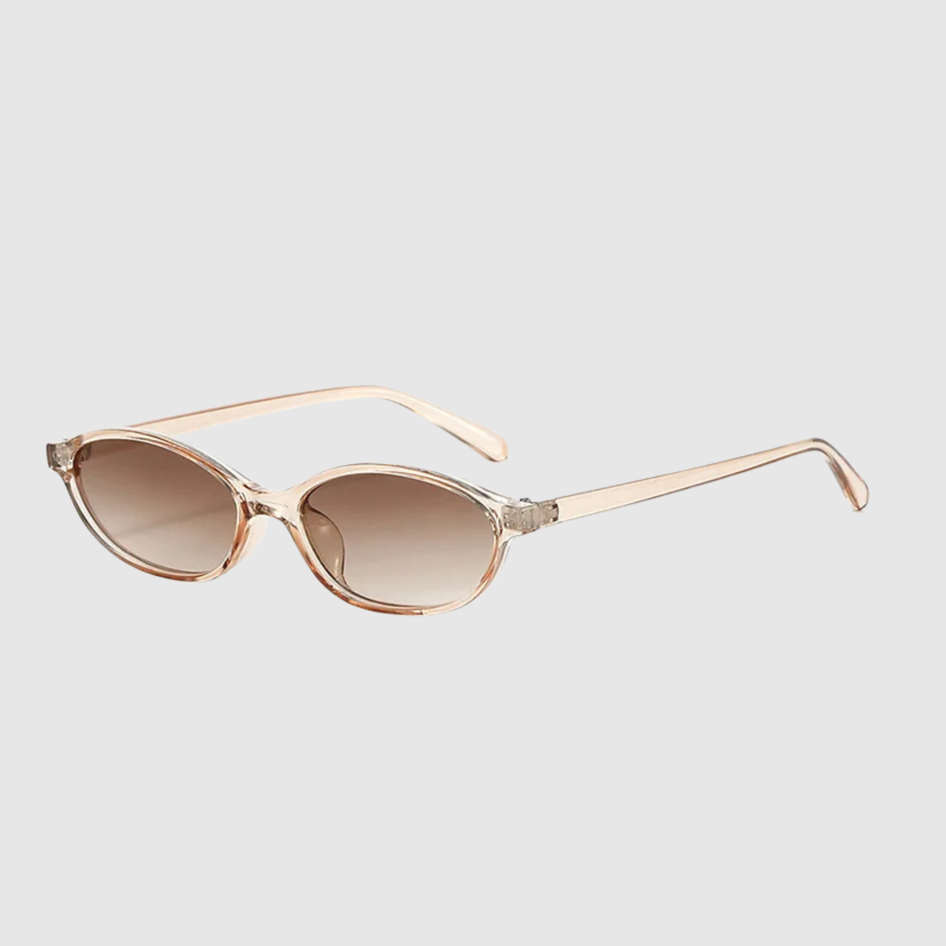 Sunglasses with clear frame and brown gradient lenses on a light gray background